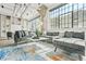 Bright and airy loft living room with exposed ceiling, white brick, sectional couch, and large windows at 434 Marietta St Nw # 401, Atlanta, GA 30313