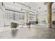 Spacious loft living room with concrete floors, neutral furnishings, and exposed brick and beams at 434 Marietta St Nw # 401, Atlanta, GA 30313