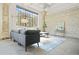 Modern loft apartment features large windows, concrete floor, exposed brick wall, and gray sectional sofa at 434 Marietta St Nw # 401, Atlanta, GA 30313