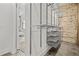 Large walk-in closet with adjustable metal shelving, open storage and exposed brick wall at 434 Marietta St Nw # 401, Atlanta, GA 30313