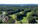 Scenic aerial view of the golf course, club house, and beautiful wooded surroundings at 1328 Amberwood Dr, Woodstock, GA 30189