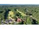 Scenic aerial view of a lush golf course surrounded by mature trees and a clubhouse at 1328 Amberwood Dr, Woodstock, GA 30189