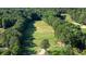 Aerial view of golf course with tree-lined fairways and manicured greens at 1328 Amberwood Dr, Woodstock, GA 30189