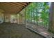 Spacious backyard features a covered patio, stairs to the upper deck, and serene wooded views at 1328 Amberwood Dr, Woodstock, GA 30189