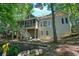 Exterior view of a home featuring a screened-in porch, back deck, and serene natural surroundings at 1328 Amberwood Dr, Woodstock, GA 30189