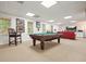 Finished basement featuring a pool table, seating, and natural light from windows at 1328 Amberwood Dr, Woodstock, GA 30189