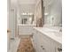 Bright bathroom features white cabinets, double sinks, large mirrors, and stylish decor at 1328 Amberwood Dr, Woodstock, GA 30189