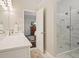 Bathroom featuring white countertops, walk-in shower, and wood grain flooring at 1328 Amberwood Dr, Woodstock, GA 30189