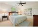 Bright bedroom with ceiling fan, neutral carpet, and decorative artwork at 1328 Amberwood Dr, Woodstock, GA 30189