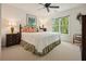Bright bedroom features a large window, neutral walls, and patterned bedding and carpet at 1328 Amberwood Dr, Woodstock, GA 30189