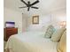 Cozy bedroom with ceiling fan, white bedding, and decorative pillows at 1328 Amberwood Dr, Woodstock, GA 30189