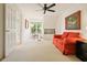 Bright bonus room with natural light from a large window; features sitting area, desk and neutral carpet at 1328 Amberwood Dr, Woodstock, GA 30189