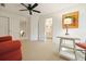Bright bonus room with neutral carpet, ceiling fan, closet, multiple doors and dog art at 1328 Amberwood Dr, Woodstock, GA 30189