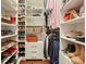 Well-organized walk-in closet with shelves and rods for storage of clothes, shoes, and accessories at 1328 Amberwood Dr, Woodstock, GA 30189