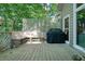 Outdoor deck with a built-in bench, black grill, and wooded views at 1328 Amberwood Dr, Woodstock, GA 30189