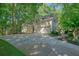 Beautifully landscaped exterior of home with large driveway and well-maintained lawn at 1328 Amberwood Dr, Woodstock, GA 30189