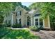 Charming two-story home with a brick facade and beautifully landscaped front yard at 1328 Amberwood Dr, Woodstock, GA 30189