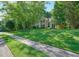 A spacious home with a lush green lawn and mature trees, creating a serene setting at 1328 Amberwood Dr, Woodstock, GA 30189