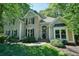 Charming two-story home with a brick facade and beautifully landscaped front yard at 1328 Amberwood Dr, Woodstock, GA 30189