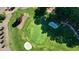 Aerial view of a well-maintained green with sand traps and lush grass at 1328 Amberwood Dr, Woodstock, GA 30189