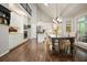 Bright kitchen featuring white cabinets, stainless steel appliances, and eat-in dining area at 1328 Amberwood Dr, Woodstock, GA 30189