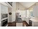 Bright kitchen with stainless appliances, granite counters, and white cabinetry at 1328 Amberwood Dr, Woodstock, GA 30189