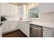 Bright kitchen with white cabinets, stainless steel appliances, and quartz countertops at 1328 Amberwood Dr, Woodstock, GA 30189