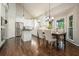 Kitchen with stainless steel appliances, white cabinets, an island, and an adjacent dining area at 1328 Amberwood Dr, Woodstock, GA 30189