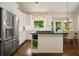Modern kitchen with stainless steel appliances, white cabinets, and center island at 1328 Amberwood Dr, Woodstock, GA 30189