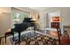 Sophisticated living room features a grand piano and elegant decor at 1328 Amberwood Dr, Woodstock, GA 30189