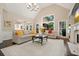 Open living space with vaulted ceiling, fireplace, and large windows for natural light at 1328 Amberwood Dr, Woodstock, GA 30189