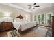 Main bedroom with natural light, dark wood floors and furniture, and tray ceilings at 1328 Amberwood Dr, Woodstock, GA 30189