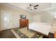 Large main bedroom with tray ceiling, dark wood floors, and walk out door at 1328 Amberwood Dr, Woodstock, GA 30189