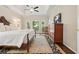 Spacious main bedroom with tray ceiling, large windows, and dark wood furniture at 1328 Amberwood Dr, Woodstock, GA 30189