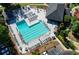 Aerial view of a large community pool with sundeck, lounge chairs, and well-manicured landscaping at 1328 Amberwood Dr, Woodstock, GA 30189