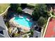Aerial view of community pool with lounge chairs, mature trees, and shade areas at 1328 Amberwood Dr, Woodstock, GA 30189