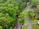 Aerial view of a cozy home surrounded by mature trees and lush greenery at 1822 Oriole Trl, Lithia Springs, GA 30122
