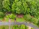 Aerial view showcases the cozy residence nestled among lush trees in a quiet neighborhood at 1822 Oriole Trl, Lithia Springs, GA 30122