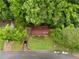 Aerial view showcases the charming residence nestled among lush trees in a quiet neighborhood at 1822 Oriole Trl, Lithia Springs, GA 30122