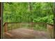 Spacious wooden back deck overlooking lush greenery, ideal for outdoor relaxation and entertaining at 1822 Oriole Trl, Lithia Springs, GA 30122