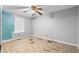 Empty bedroom featuring a ceiling fan, window with blinds and worn out floors at 1822 Oriole Trl, Lithia Springs, GA 30122