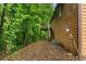 Exterior view of home featuring wood siding and a deck, surrounded by mature trees at 1822 Oriole Trl, Lithia Springs, GA 30122