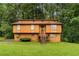Two-story home with wood siding, lawn, and mature trees at 1822 Oriole Trl, Lithia Springs, GA 30122