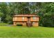 Two-story home with wood paneling surrounded by lush green trees and lawn at 1822 Oriole Trl, Lithia Springs, GA 30122