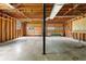 Unfinished two car garage with two wooden doors, open wooden walls and concrete floor at 1822 Oriole Trl, Lithia Springs, GA 30122