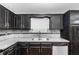 Kitchen featuring granite countertops, stainless steel appliances and black cabinets at 1822 Oriole Trl, Lithia Springs, GA 30122