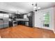 Kitchen featuring wood floors, stainless steel appliances, granite countertops and black cabinets at 1822 Oriole Trl, Lithia Springs, GA 30122