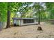 View of the backyard showing the trees surrounding the home with many large windows at 4212 Bryan Se Dr, Acworth, GA 30102