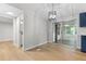 Bright dining area with modern light fixture and sliding glass doors to an enclosed porch at 4212 Bryan Se Dr, Acworth, GA 30102