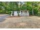 Exterior view of a home featuring a covered porch, complemented by well-maintained landscaping and an abundant tree line at 4212 Bryan Se Dr, Acworth, GA 30102